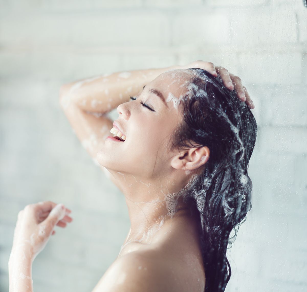 Woman happy while shampooing.