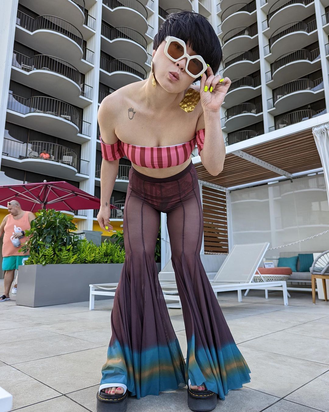 Atsuko Okatsuka posing with her sunglasses and a bowl cut.