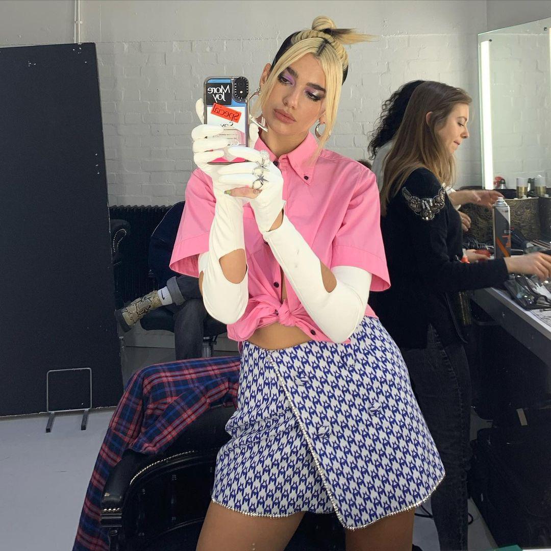 Dua Lipa in a pink shirt and bleached hair