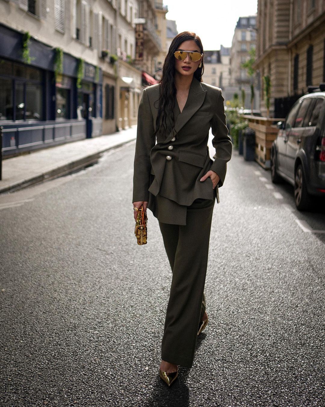 Beauty queen Pia Wurtzbach walking on street in army green pantsuit.