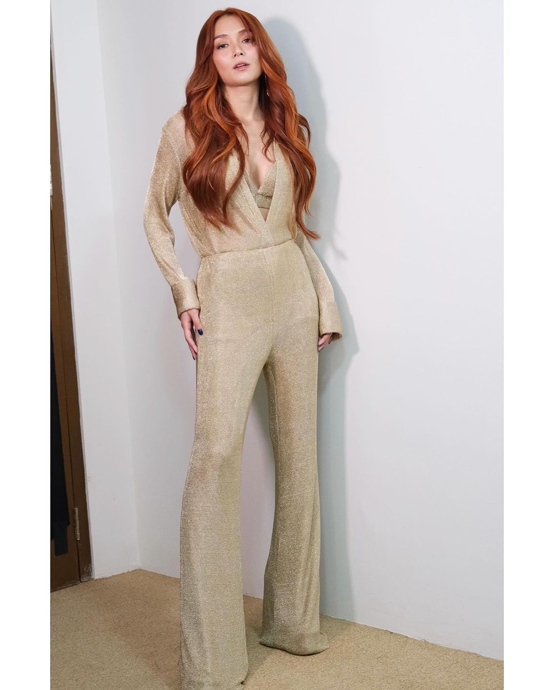 Actress Kathryn Bernardo in a gold jumpsuit.