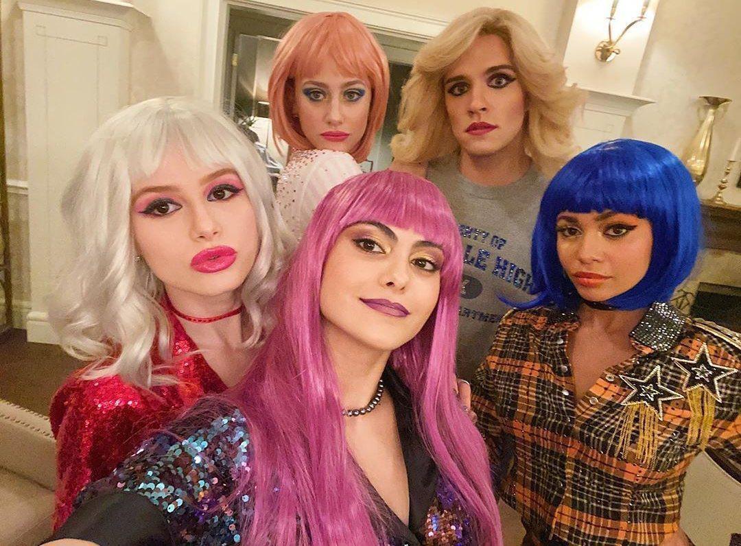 People wearing different colored wigs