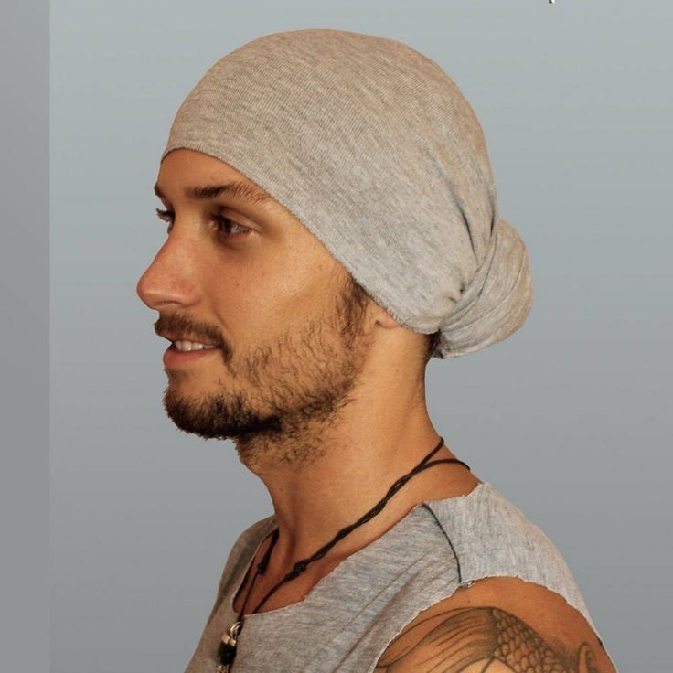 A portrait of man with a gray hair wrap.