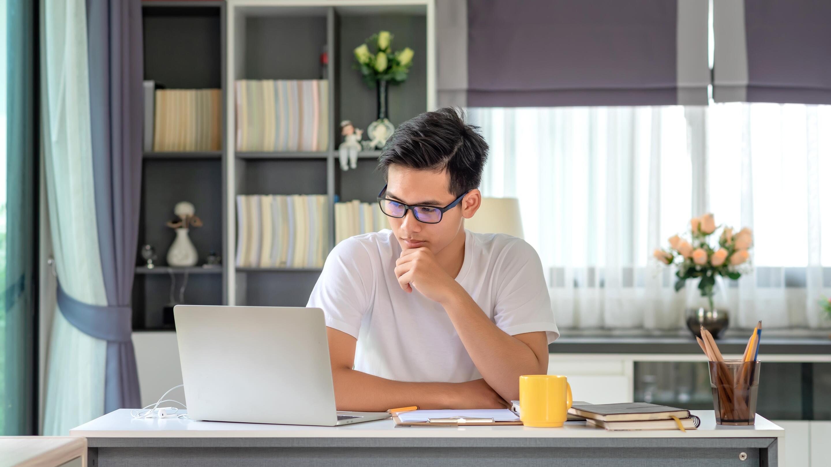 Asian man working hard at home