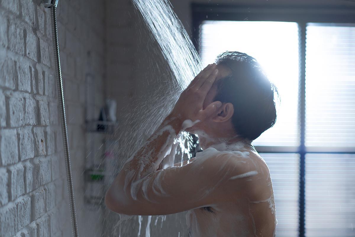 Asian man taking a shower