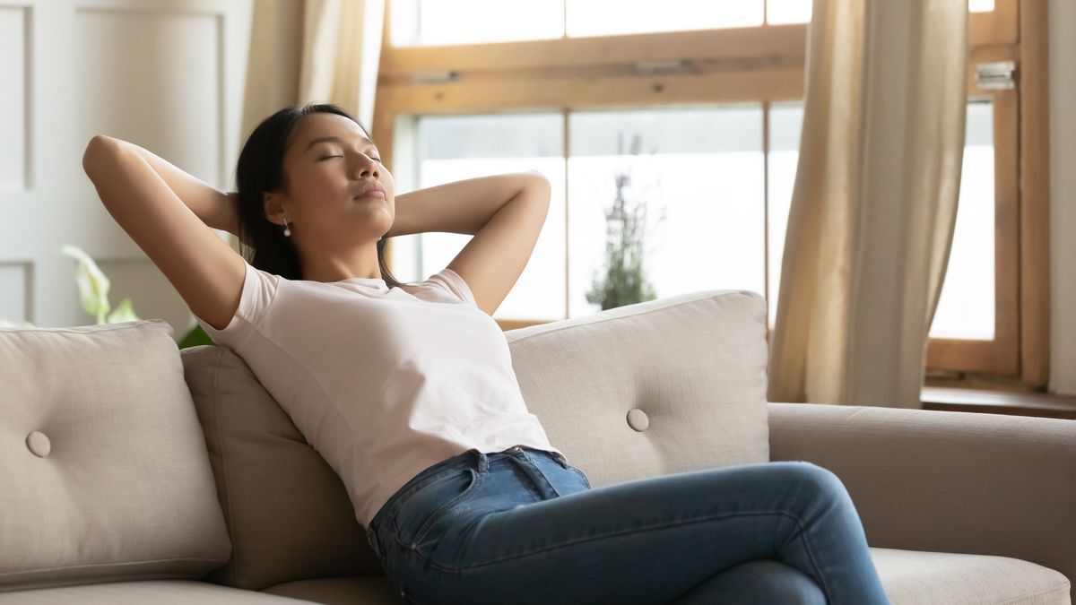 Filipino woman relaxing on couch. 