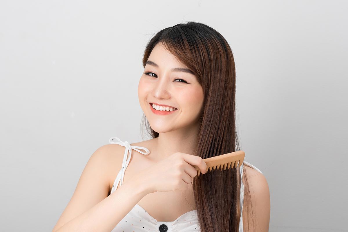 Woman combs her long hair