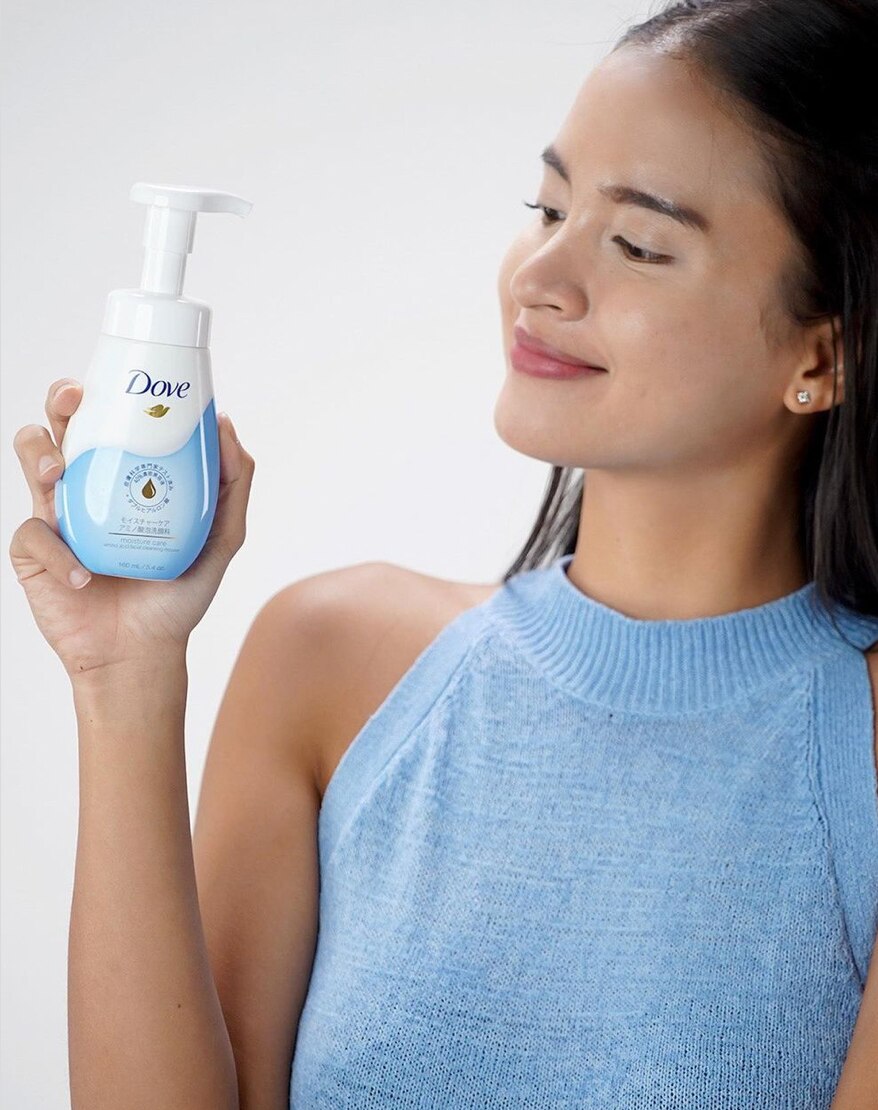Filipina holding a skincare product