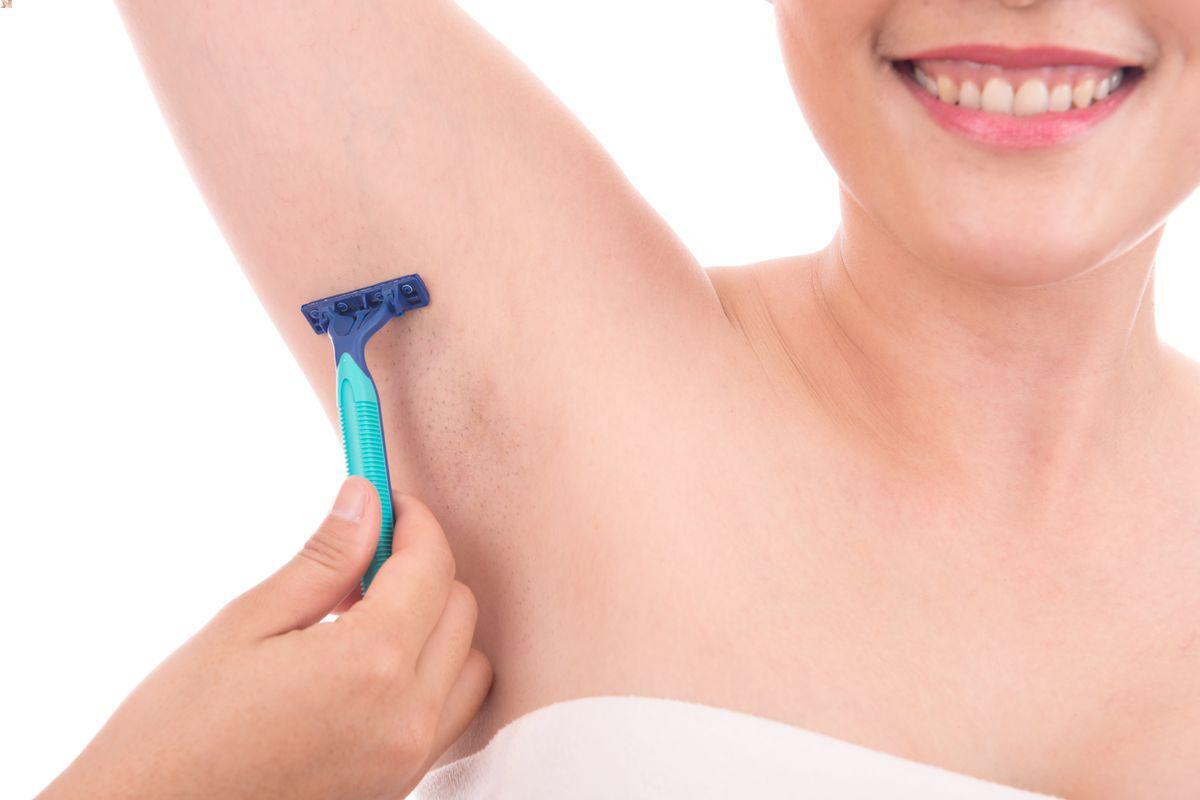 Asian woman shaving armpit hair