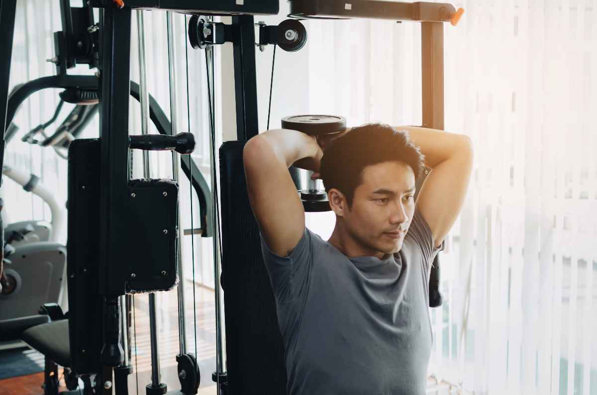 Man using dumbbell exercise to work his biceps at the gym.  