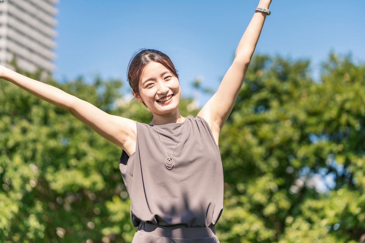 Woman lifting her arms in the air.