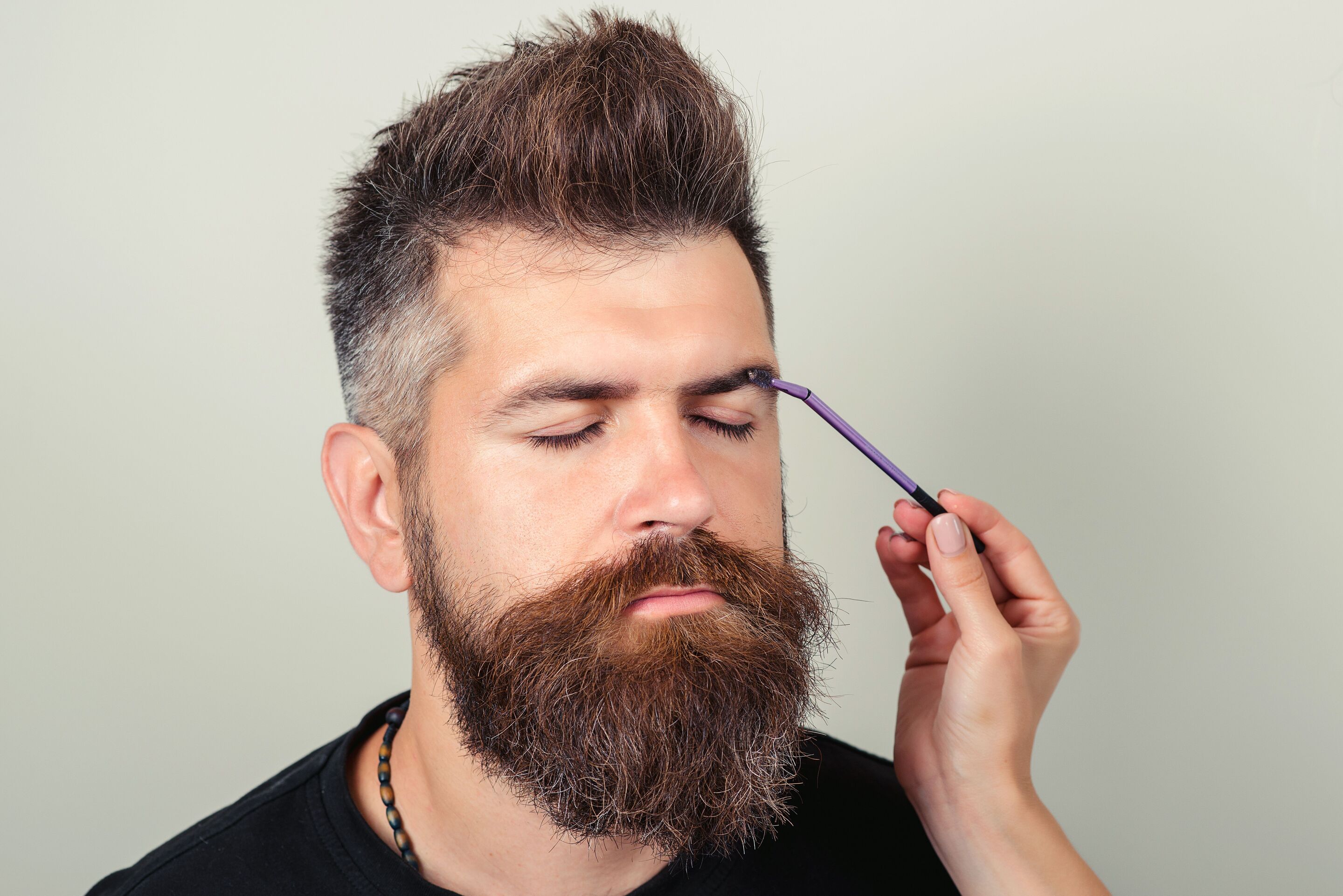 Man having his eyebrows plucked