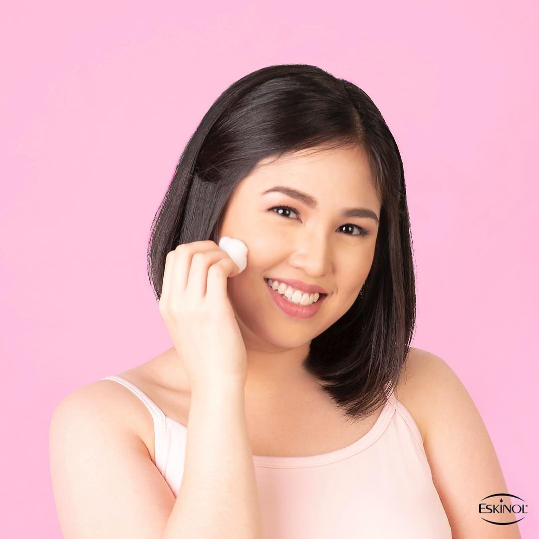 A young woman using Eskinol to clean her skin