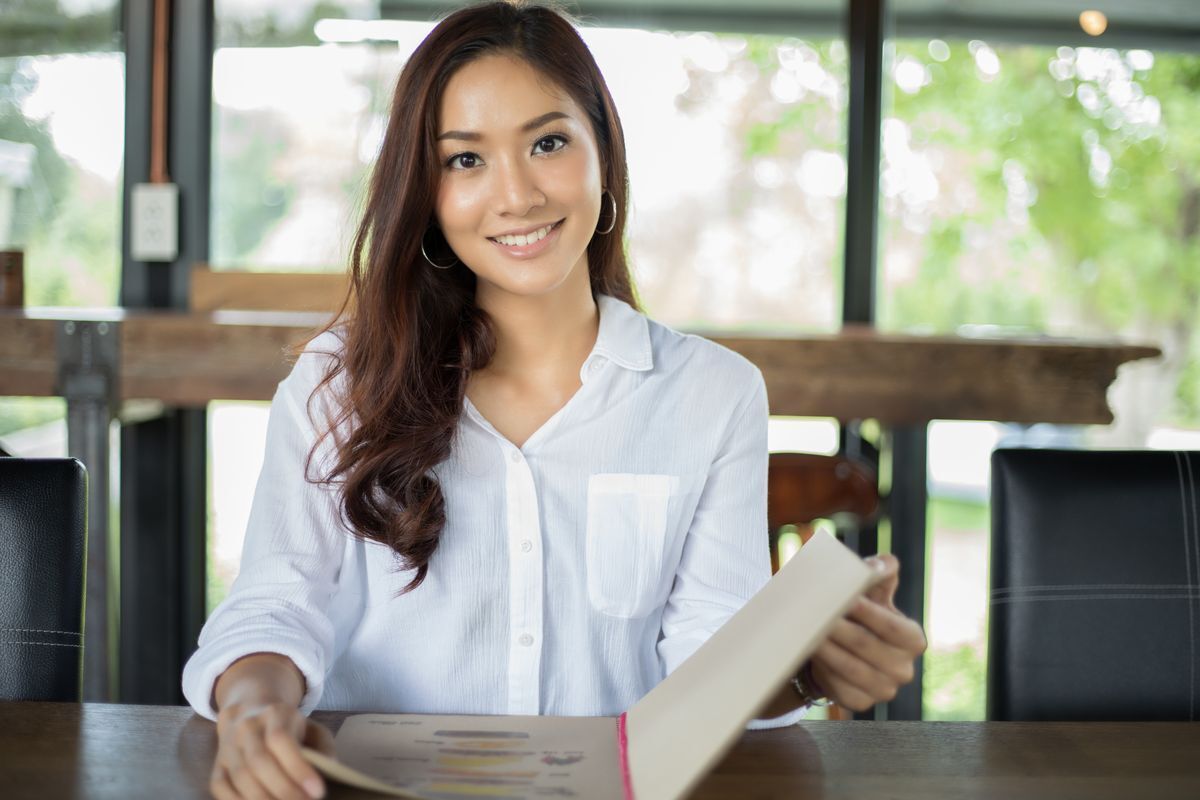 Asian woman in café smiling
