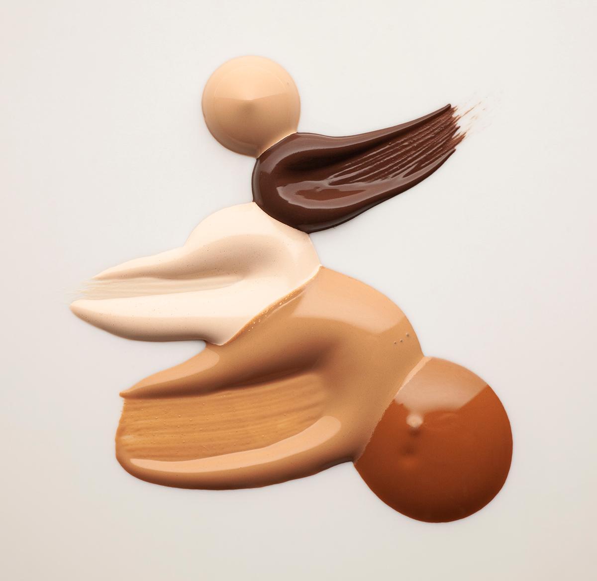 Swatches of foundation against a neutral background