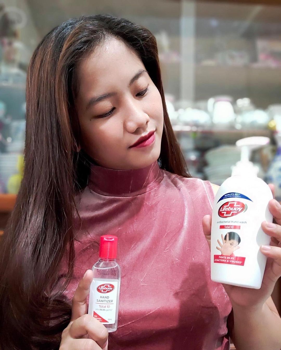 A Filipina holding Lifebuoy products
