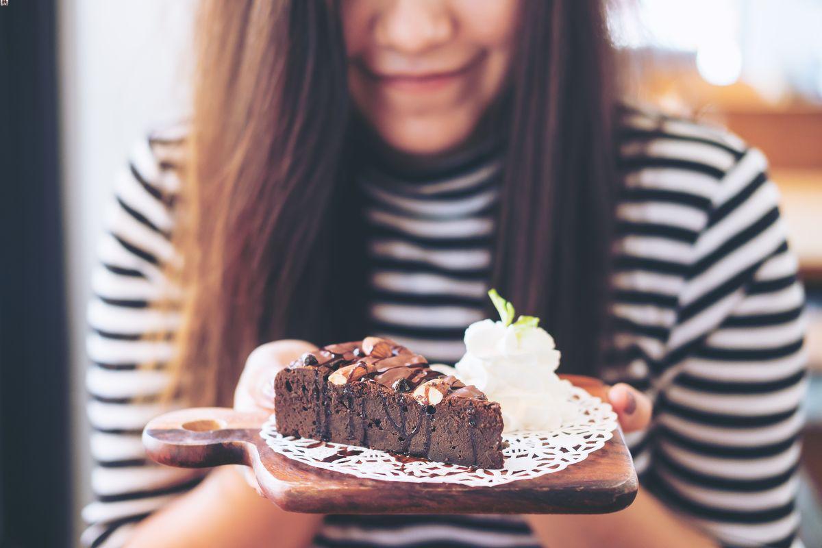 Asian woman looking at chocolate.