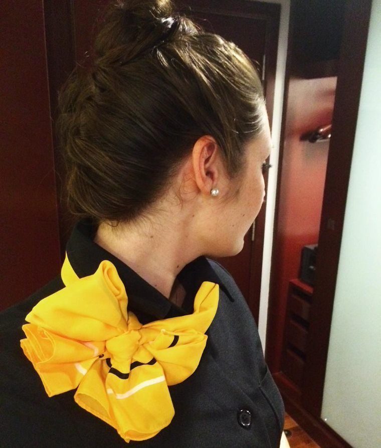 Female flight attendant with a braided updo.