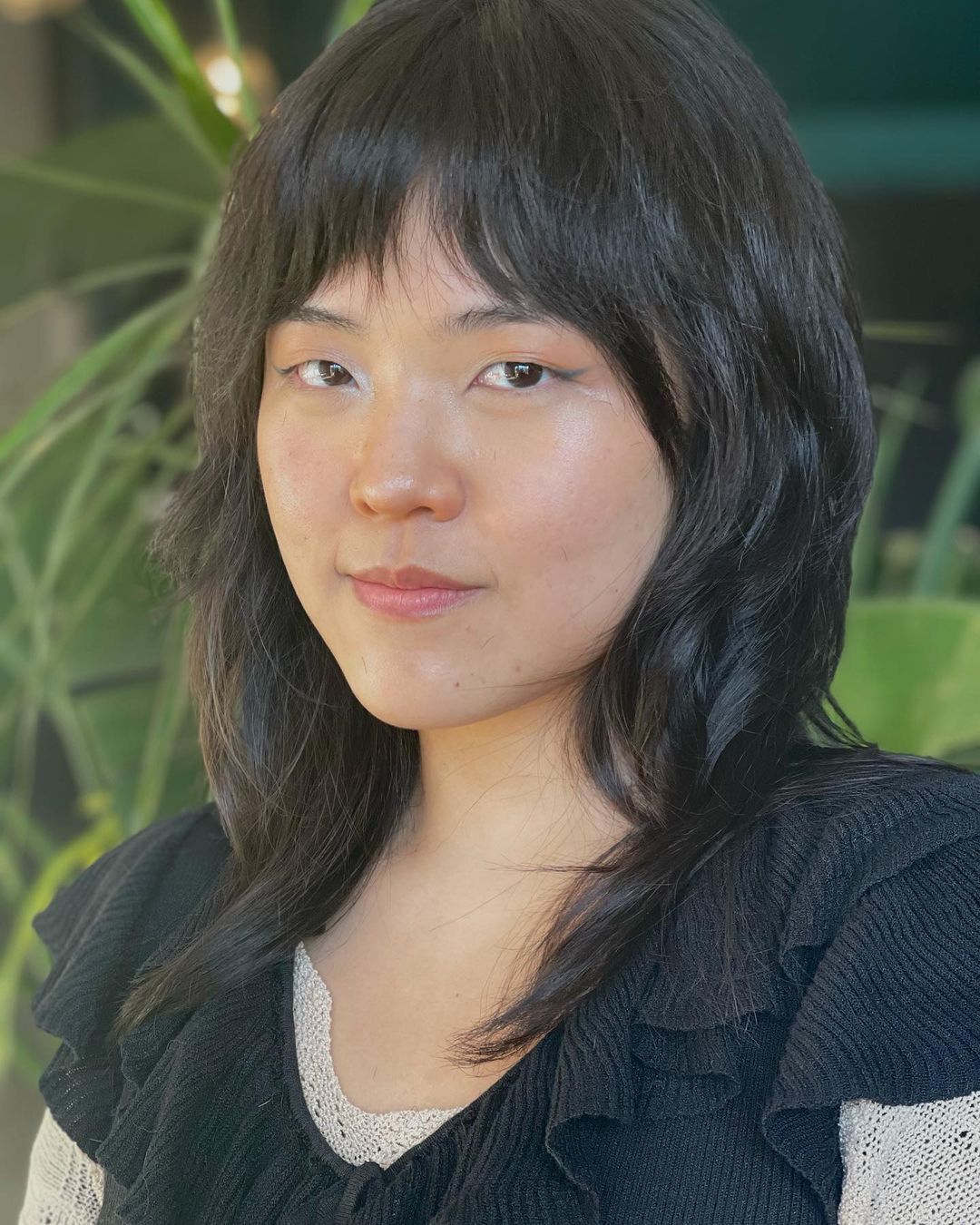 Woman with medium-length hair and bottleneck bangs.
