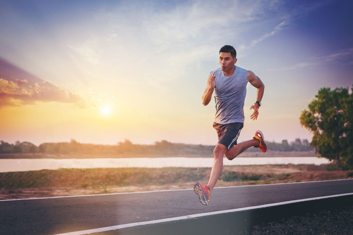 Asian man running on road