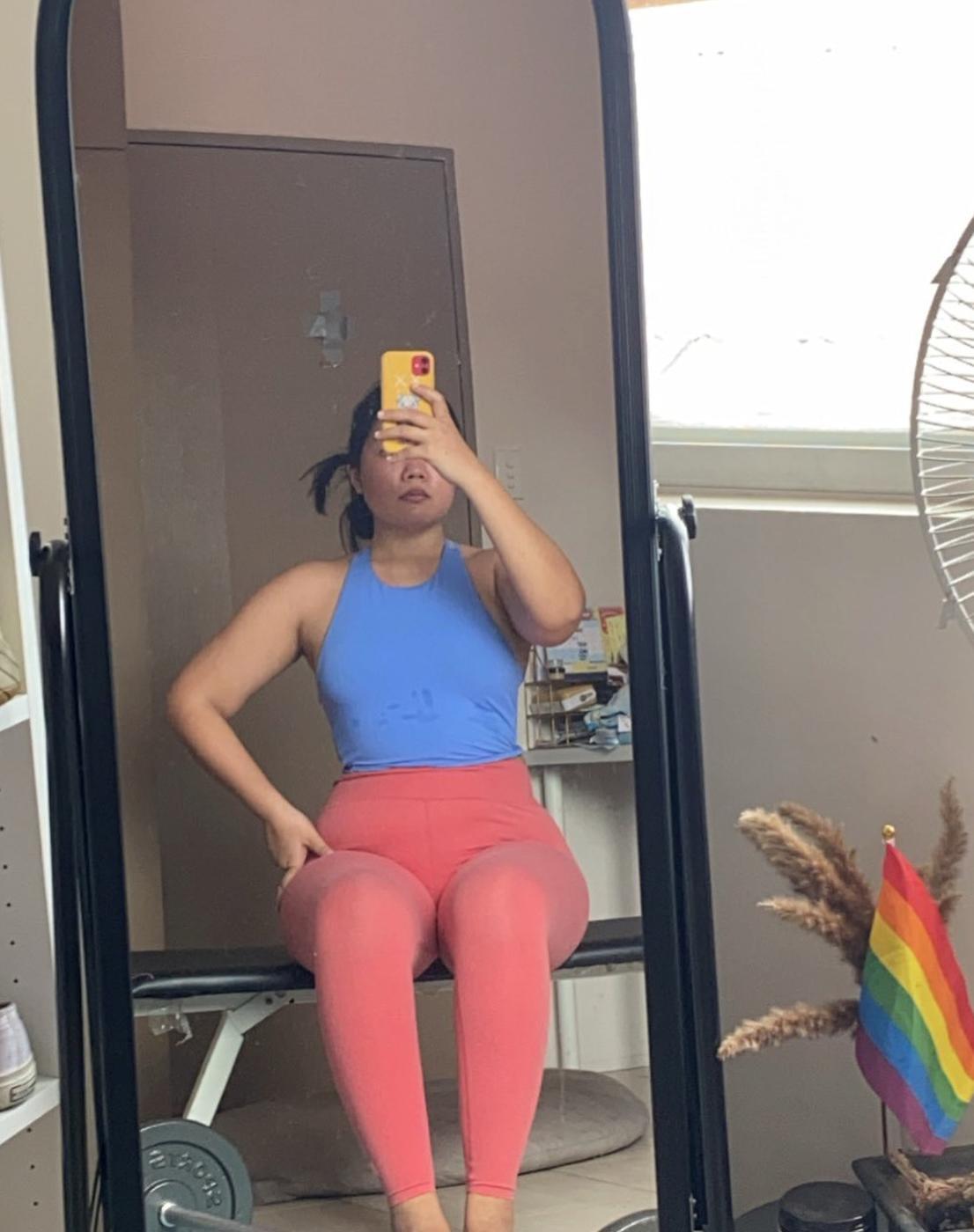Woman taking a mirror selfie after working out