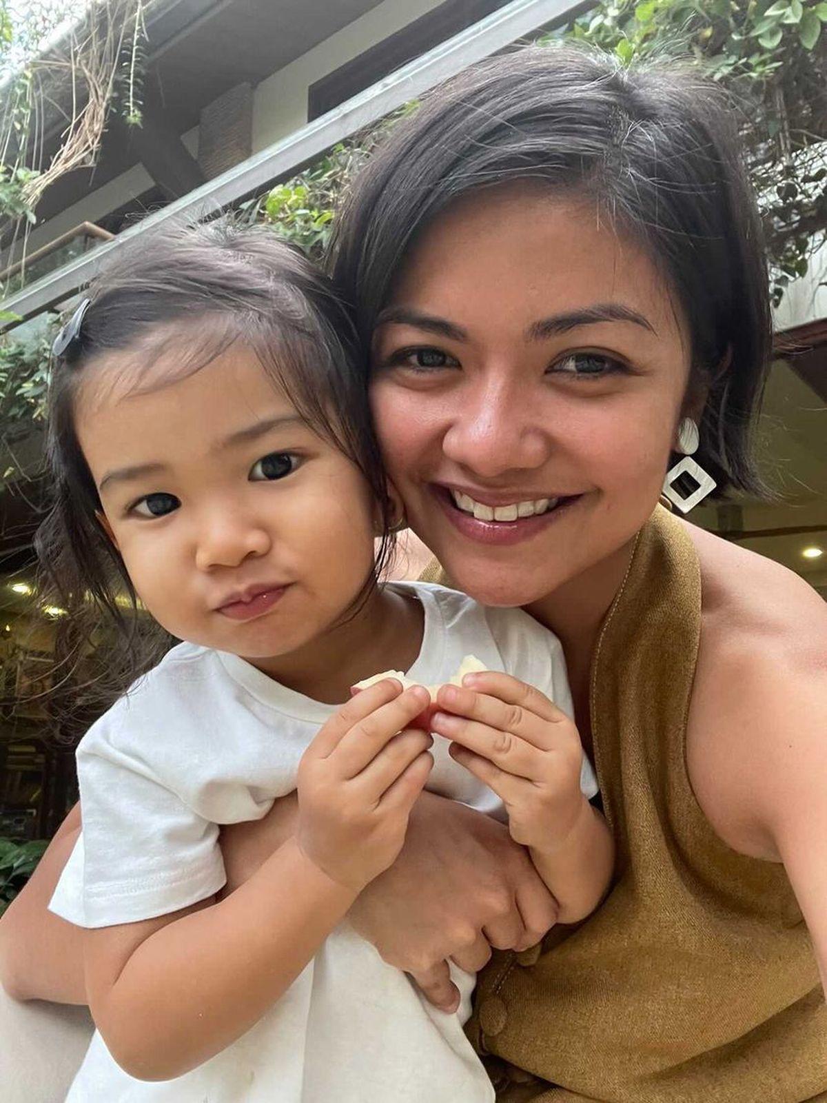 Woman with short hair and baby daughter 