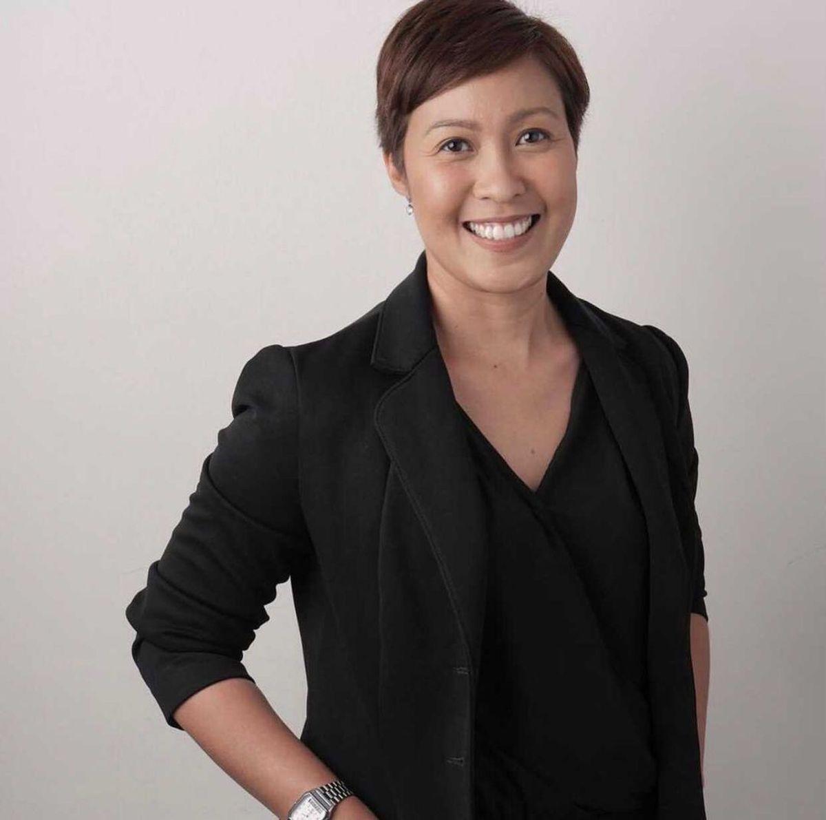 Woman in pixie hair wearing black 