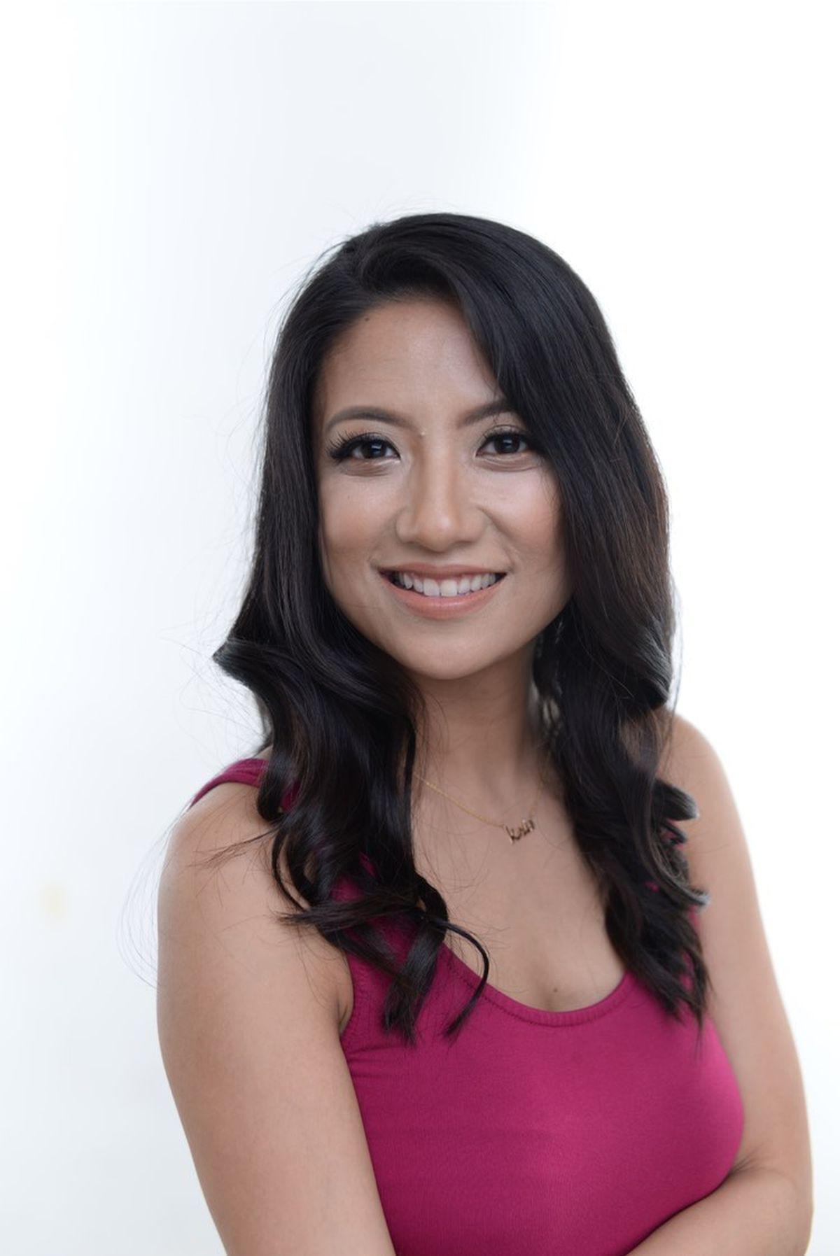 Woman with long hair in maroon shirt 