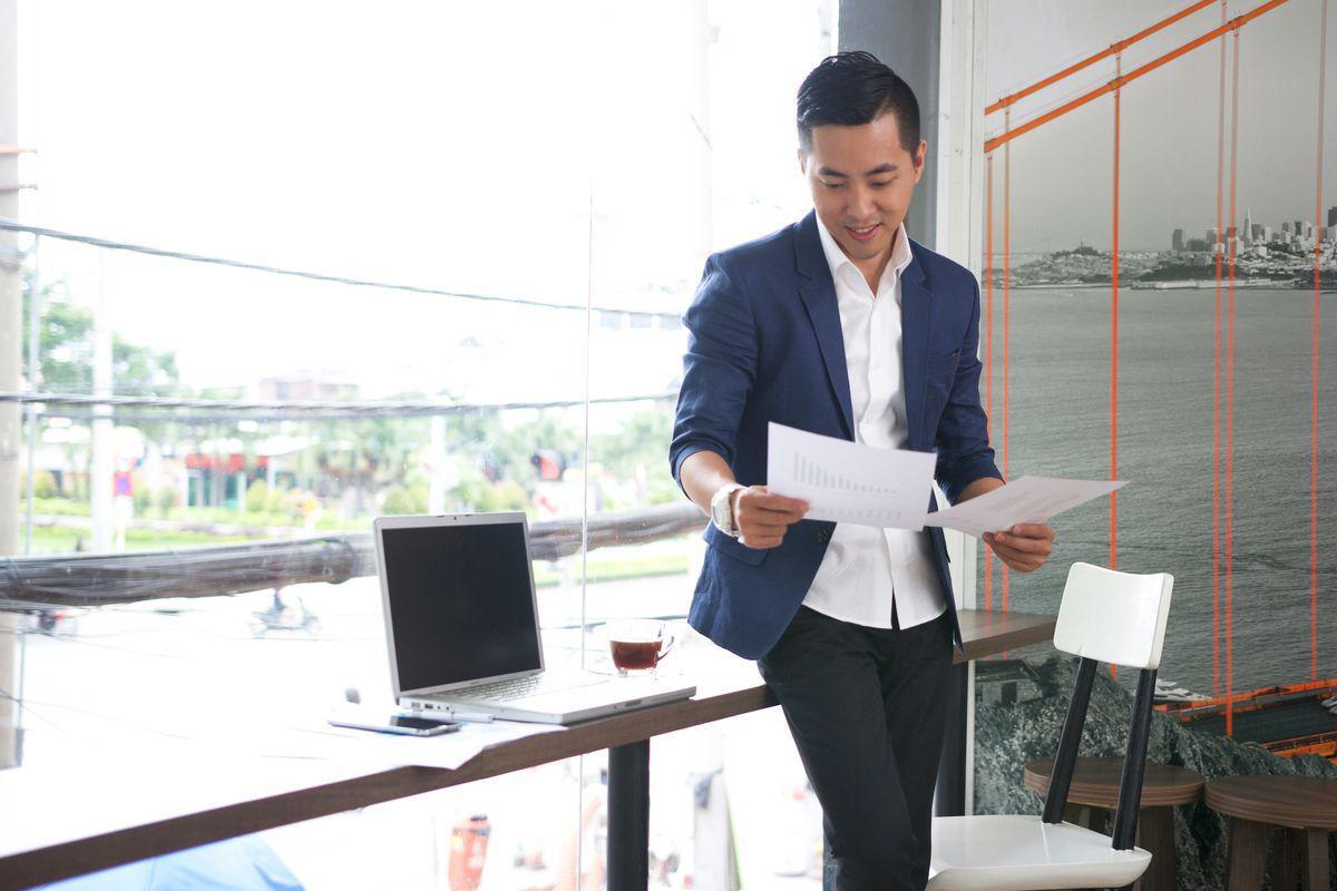 Asian man in the office looking at documents
