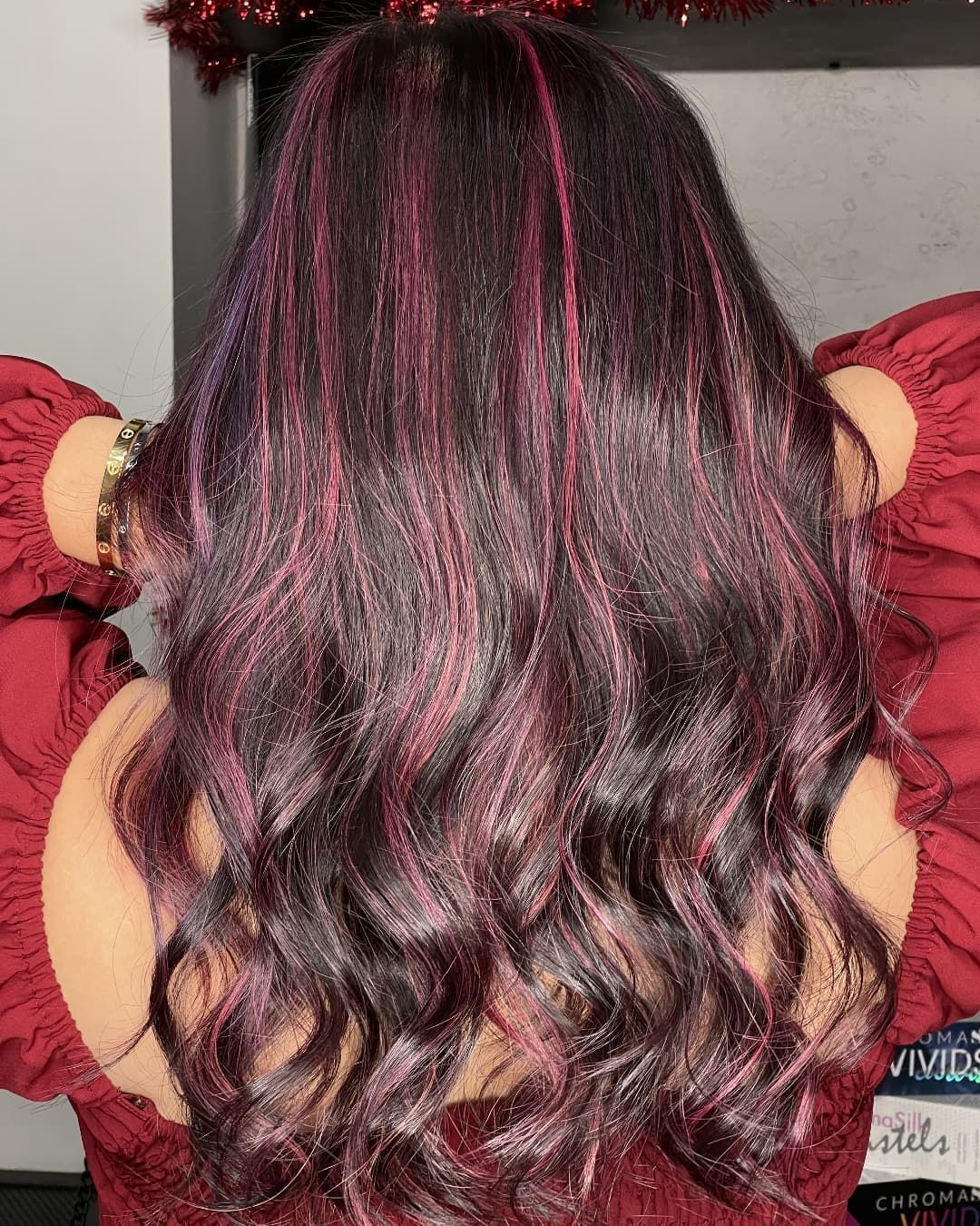 Woman with black and pink hair.