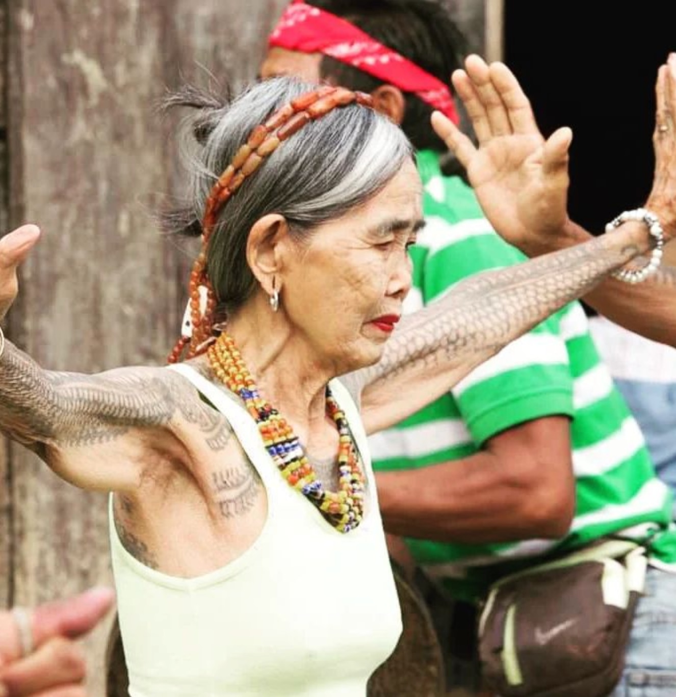 Apo Whang Od in a sleeveless top showing her tattoos.