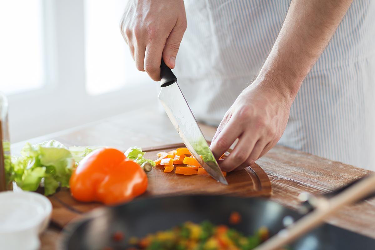 A man cooks a healthy meal in his kitchen.