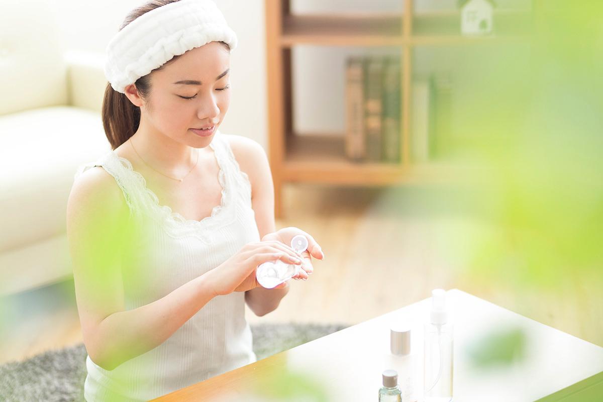 Woman doing skincare in her living room