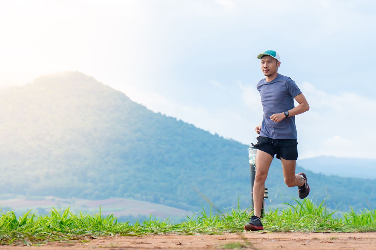 Asian man running outdoors