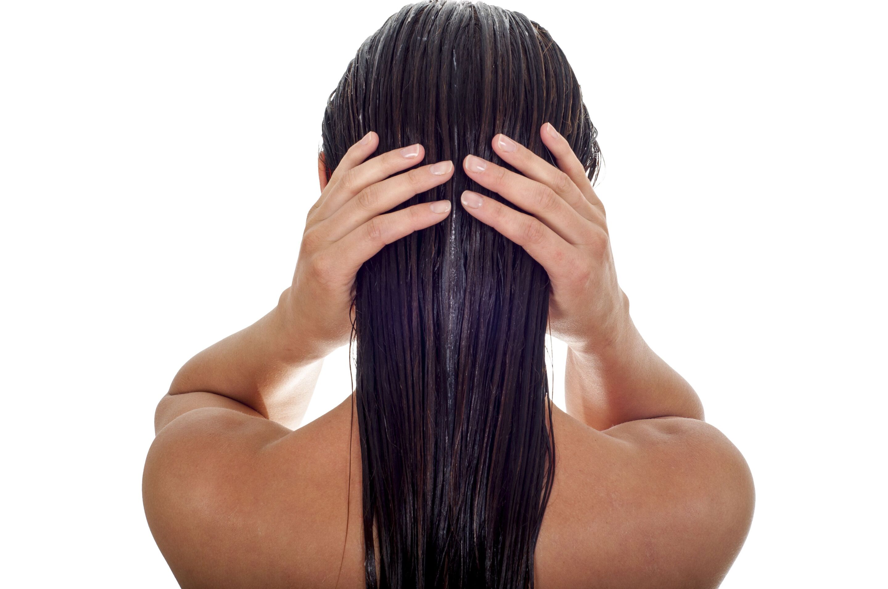 A woman applying a hair conditioner