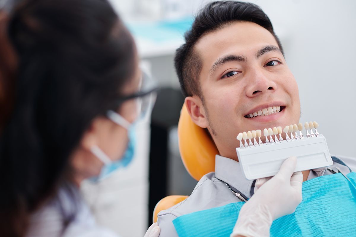 Man looking at the dentist while sitting on the patient’s chair.
