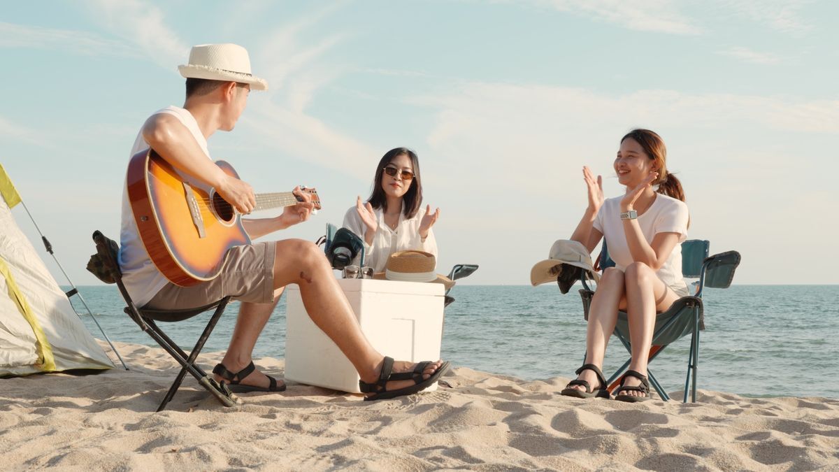 Playing guitar on the beach with friends.