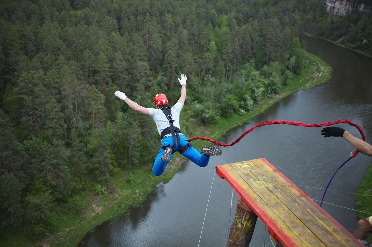 A man going bungee jumping off a cliff.