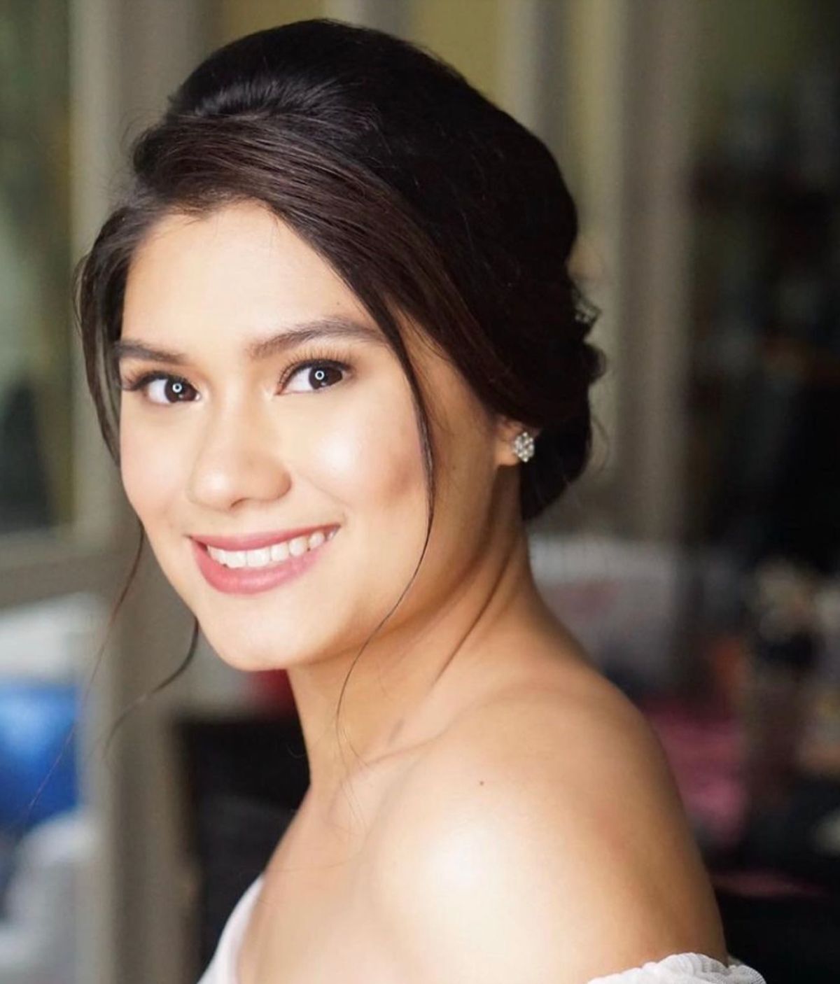 Closeup of a young Asian woman smiling in a wedding dress