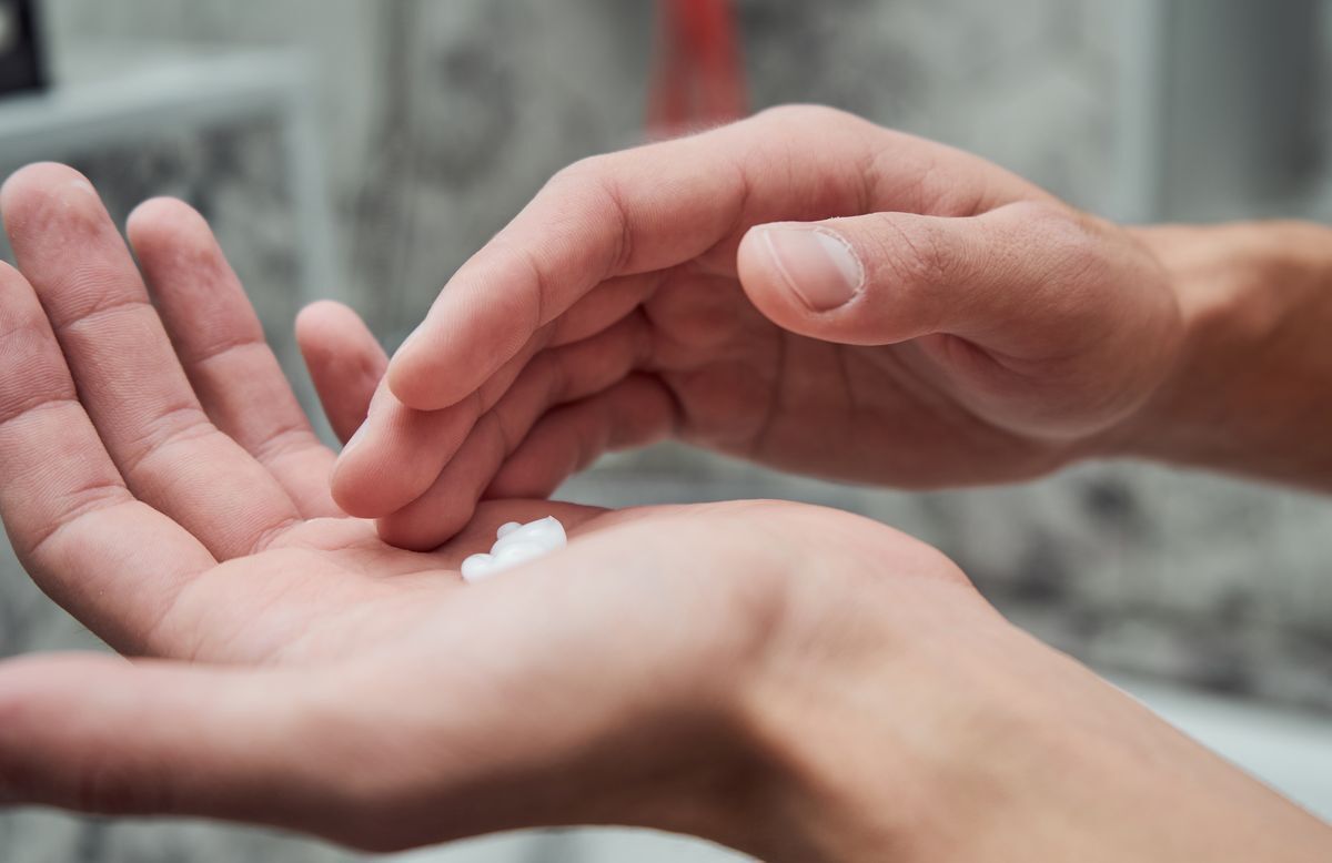 Male hands with lotion or cream