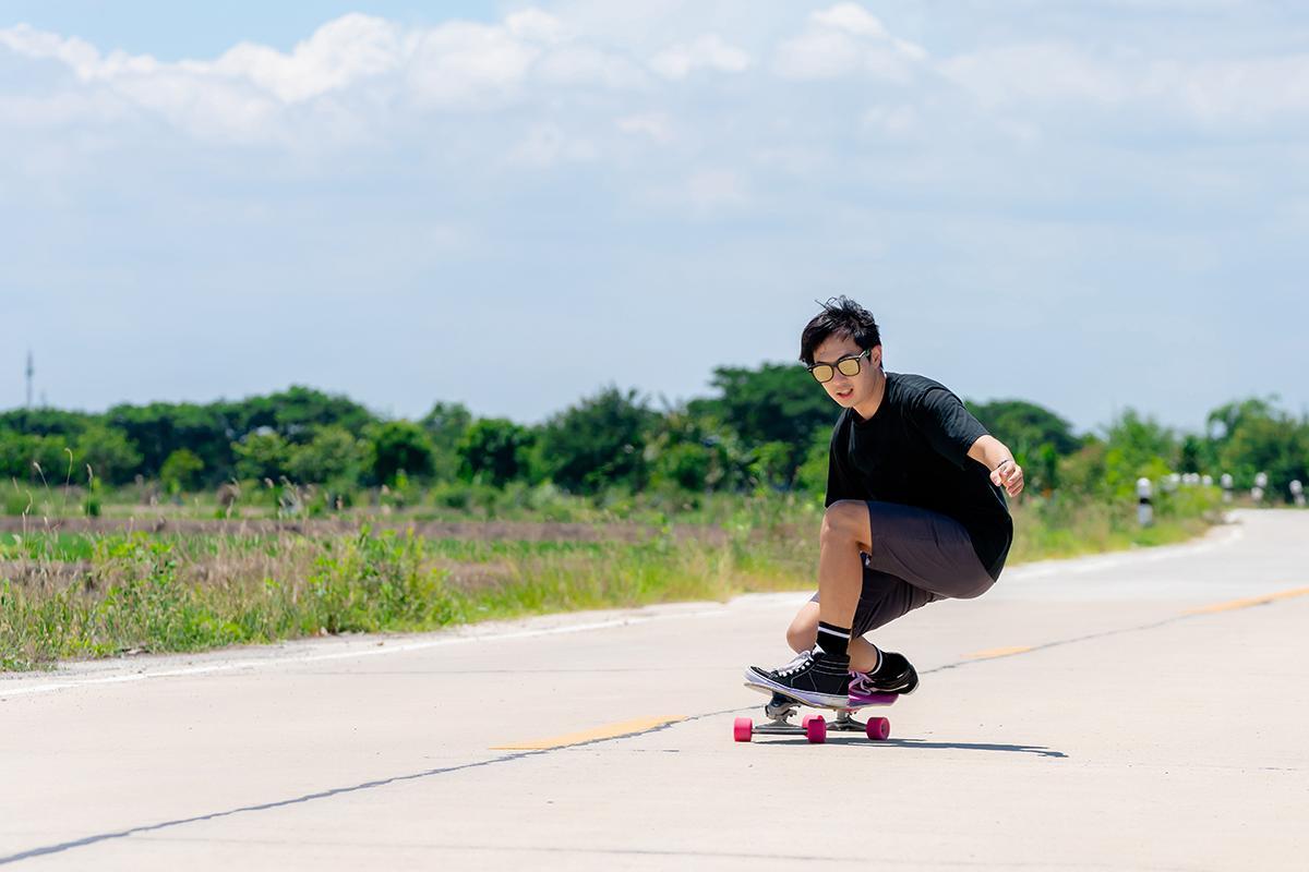 Young Asian man skateboarding