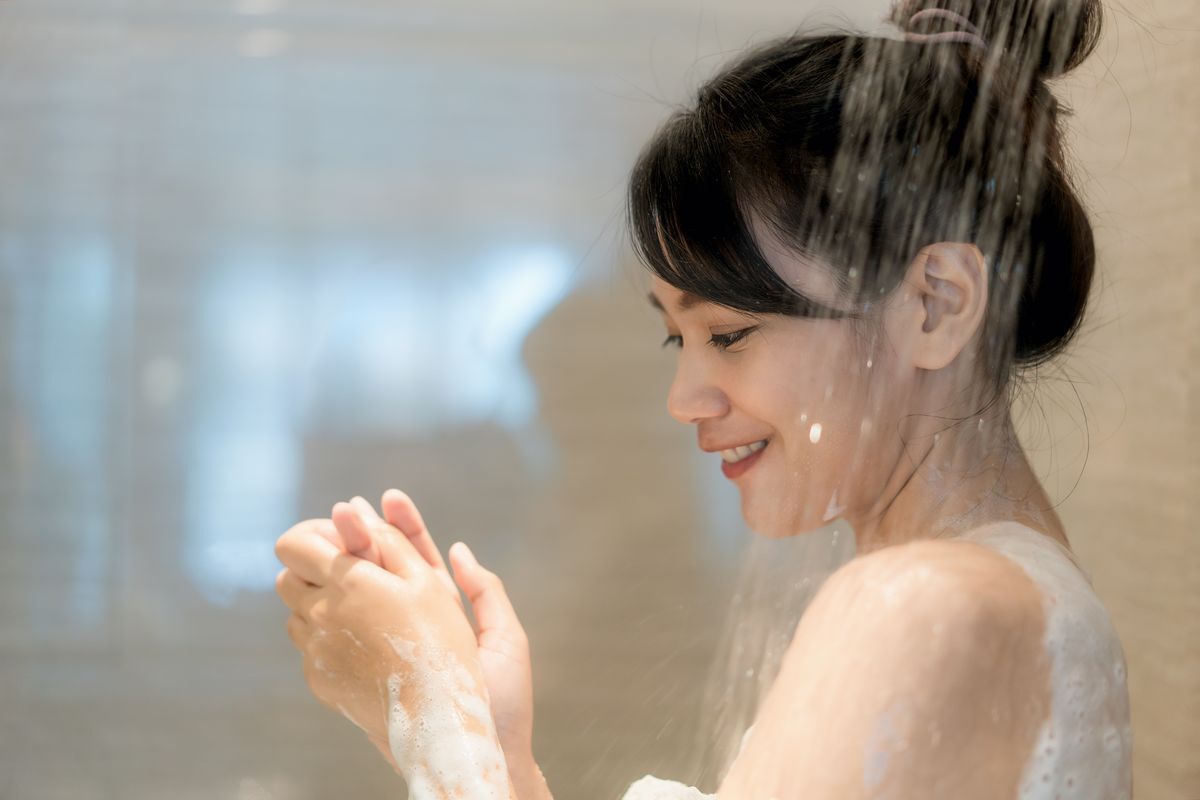 Woman washing hands in shower 