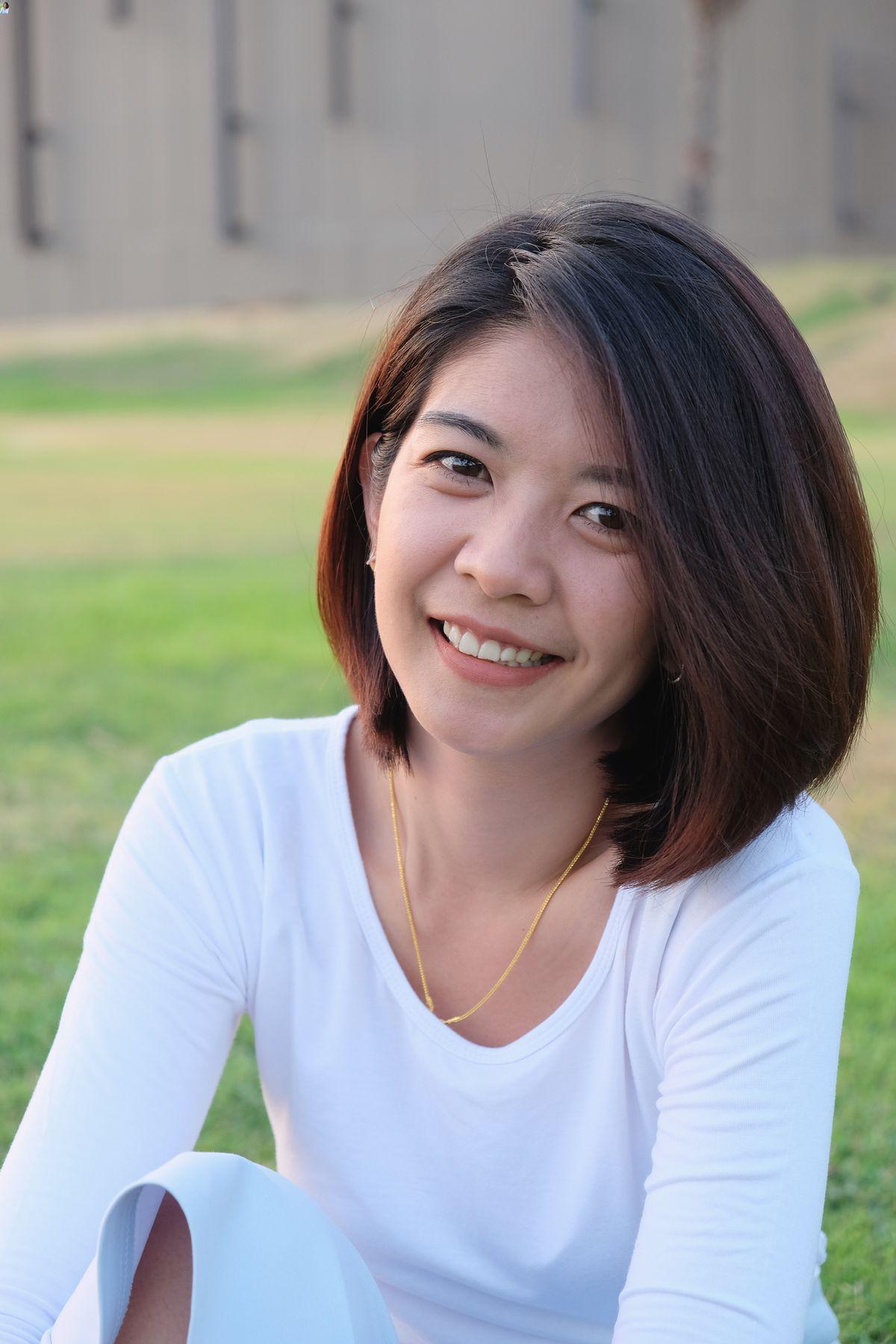 Asian woman with thick, mid length hair 