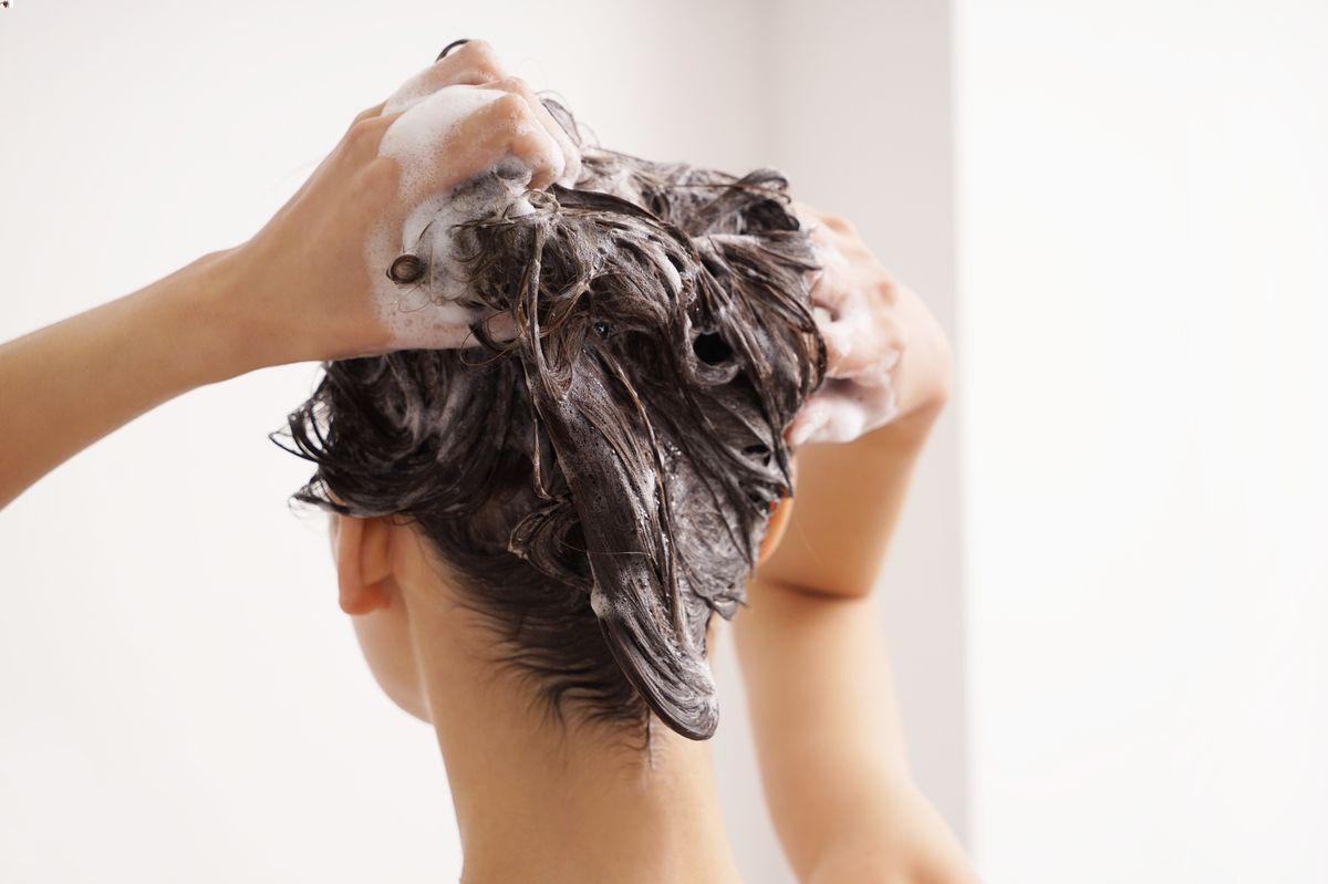 Woman washing her hair in the bathroom