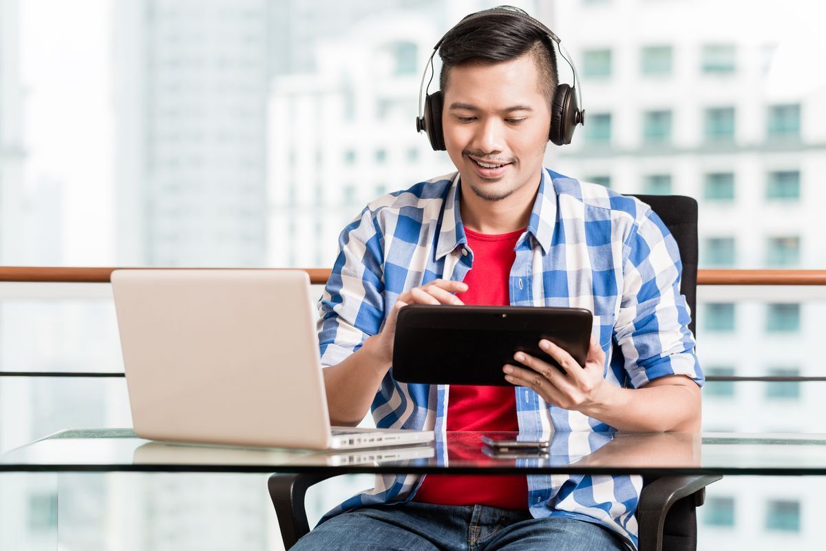 A man wearing a headset while on a conference call