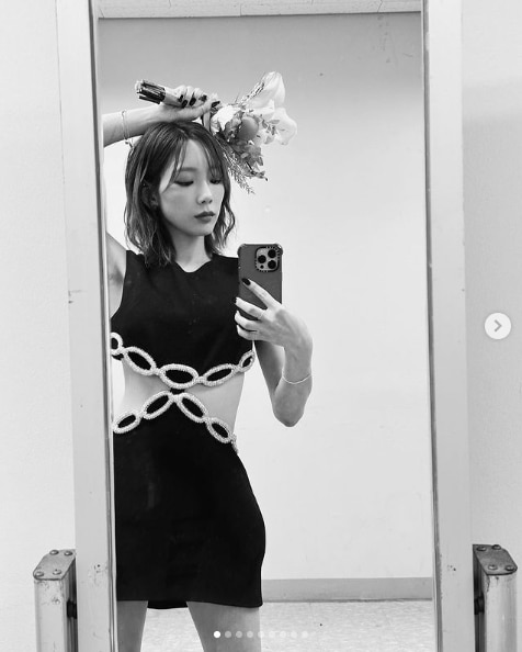 Taeyeon, a K pop soloist and member of Girls’ Generation, taking a full body mirror photo.