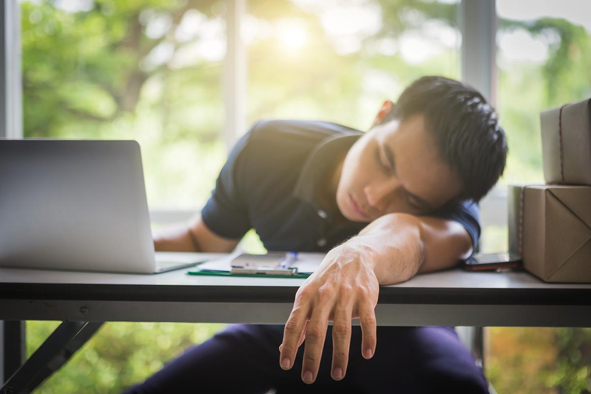 A man sleeping at desk