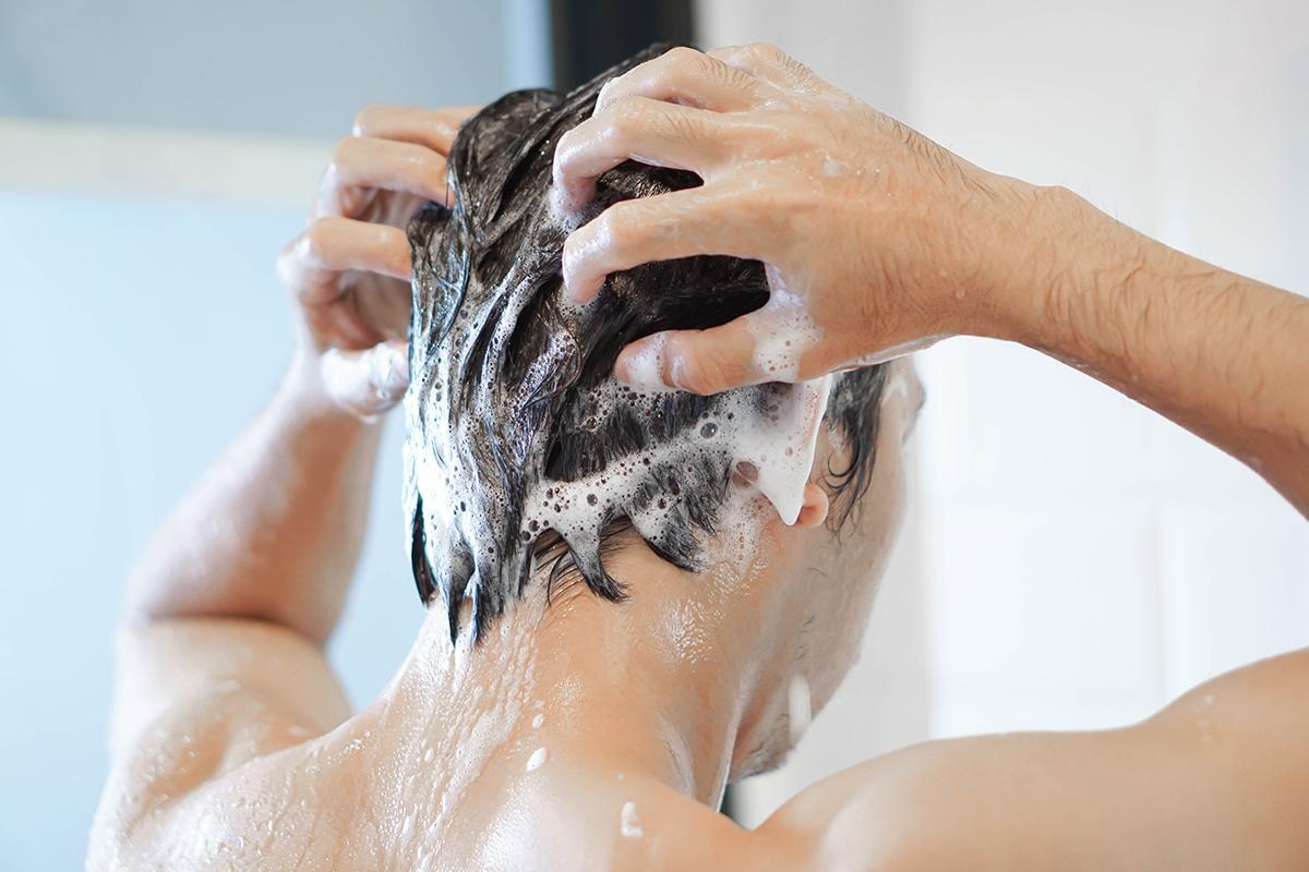 Closeup of man washing his hair
