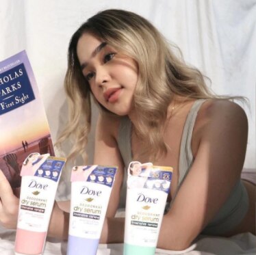 Kaila Concepcion reading a book and posing with Dove Intensive Renew Deodorant Dry Serum.