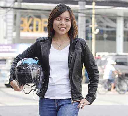 Angkas founder Angeline Tham poses with Angkas helmet on the street.